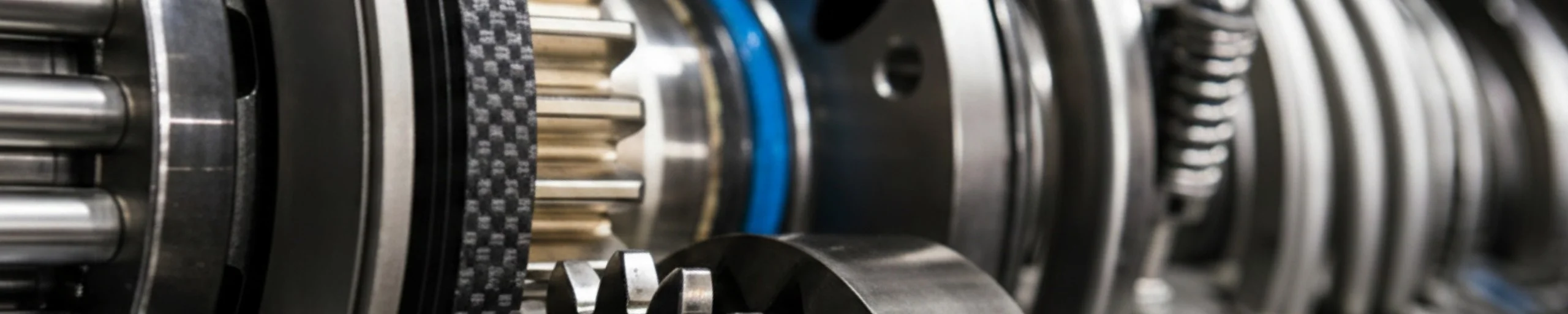 Close-up of high-precision mechanical gears, drive belts, and components of an industrial packaging machine undergoing professional maintenance by Vintor.